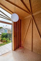 Parsonson outfitted the interior walls, floor, and ceiling with oriented strand board (OSB). Structural supports form triangles, creating an artful, geometric aesthetic.