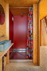 To create interest and a note of brilliance, Parsonson sided the shower walls with red Invibe panel board.&nbsp;&nbsp;