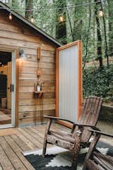 The large wood deck features an outdoor shower that helps to provide an indoor/outdoor living experience.