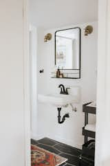 In recreating the bathroom, Mendes employed a wall-mounted sink, white-painted walls and black hexagonal floor tile.