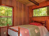 The bedroom walls and ceiling were wrapped in wood, making the space dark and cave-like.