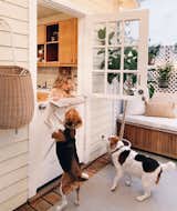 A Dutch door provides access from the kitchen to the porch, where West plays with the family's two rescue beagles, StanLee and Sophee.