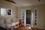 Before: Whitney maintained the original, built-in sofa in the living room.  Photo 8 of 25 in Before & After: An Eco-Friendly Family’s 400-Square-Foot Cottage Teems With Plant Life