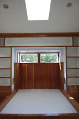 Before: The original bedroom features a built-in bed canopied by built-in shelving.   Photo 14 of 25 in Before & After: An Eco-Friendly Family’s 400-Square-Foot Cottage Teems With Plant Life