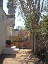 Before: The original side garden was used only as a passageway.    Photo 21 of 25 in Before & After: An Eco-Friendly Family’s 400-Square-Foot Cottage Teems With Plant Life