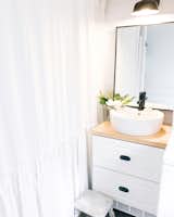 The bathroom accommodates a full-size tub and a clothes washer and dryer.