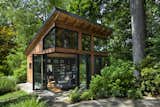 Virginia-based screenwriter Matthew Michael Carnahan’s 400-square foot work studio features NanaWall doors that fold open to connect the interior to the surrounding forest.