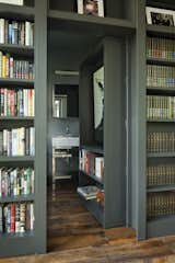 One section of the floor-to-ceiling bookshelves pivots open to reveal a concealed bathroom.&nbsp;