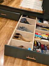 Kitchen, Colorful Cabinet, and Laminate Floor Sizable drawers beneath the kitchen floor store the couple’s clothing and shoes.  Photos from Budget Breakdown: Two Travel Therapists Build a Tiny Home-on-Wheels for $24K