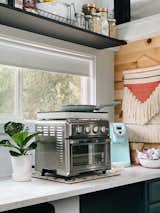 The kitchen offers plenty of counter space for cooking, which is done via a small convection oven that was gifted, and an induction cooktop that cost $40.