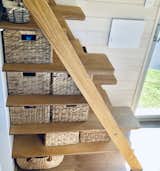 The deep treads of the Tasmanian Oak plywood staircase accommodate storage baskets. "We were looking for creative ways to provide extra storage options," Ashlee says.