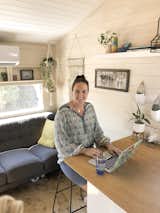 Ashlee De Campo works at the kitchen counter, which also serves as her dining area.