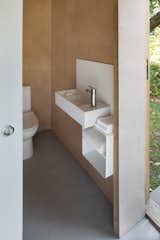 The bathroom is also outfitted with plywood walls and an epoxy resin floor.
