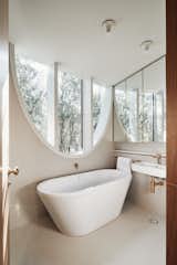 The trees around the home help to filter and soften the sunlight that pours into this bath on the second level.