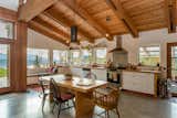 The open-plan kitchen-and-dining space features a Douglas fir ceiling and ceiling beams and polished concrete floors.