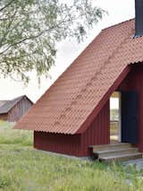 The clay pantile roof mimics the roof of the existing 19th-century barn structure that still stands on the site.