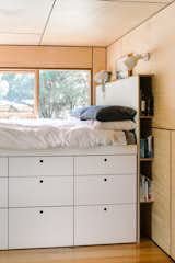 The built-in bed features a clever dresser system and a headboard that doubles as a bookshelf.