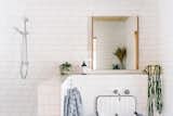 Partial walls and white subway tile create a spacious feeling for the bathroom.