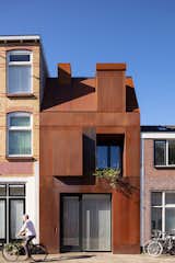 The three-story home features a front facade clad with Cor-Ten steel that both blends into—and departs from—the traditional brick facades around it.