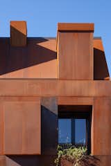 The Cor-Ten steel, now a bright orange-brown tone, will patina over time, lending a dynamic quality to the artful home.