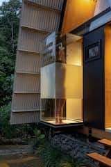 Exterior, Wood Siding Material, Glass Siding Material, and Cabin Building Type The cantilevered glass shower on the front facade features opaque banding that creates privacy.  Photo 10 of 11 in This Carbon-Negative Cabin in Ecuador Sits Lightly in a Tropical Paradise
