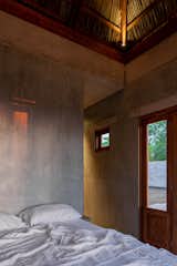 The larger stucco-clad volume houses the bedroom and the bathroom.