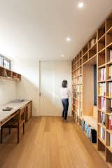 The office on the second level is outfitted with a built-in desk and bookcase that spans the length of the walls.