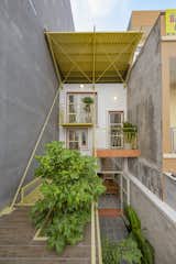 Double Roof House, a residence and small business designed by Khuon Studio, sits on a narrow lot that measures 44 by 183 feet in Ho Chi Minh City.