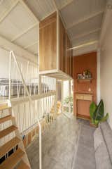 Living, Sofa, Console Tables, Wall, Concrete, Storage, and Shelves The child’s bedroom loft is situated on a split level and overlooks the living area.  Living Storage Wall Sofa Concrete Photos from Cascading Levels Bring Light and Air Into a Narrow Home in Vietnam