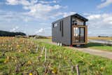 Ala Köl, the most recent design imagined by Tiny House Baluchon for a couple who love to travel, is clad with black aluminum, cedar, and glass.