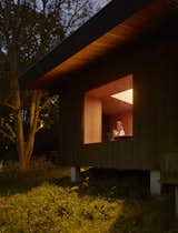 At night, the large window in the dining area creates a lantern-like effect for the cabin.