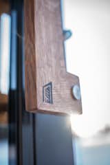 Each tiny home the Fritzes design and build is branded with the company logo on the front door wood handle.