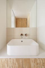 A detail shot of the bathroom sink shows off the natural grain of the pine cabinets.