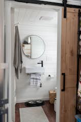 A sliding barn door accesses the bathroom, where the Jungbauers installed a compost toilet and low-flow fixtures for the sink and the shower.