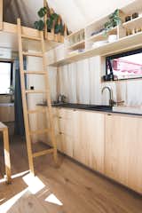Hideaway tiny cabin plywood kitchen with open shelving