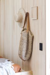 Rick included a custom picture frame fixture and wall pegs that hold personal items near the bed and bench in the living area. 