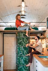 Anna and Jakob chat on the ladder that accesses the sleeping loft. Made from cast iron piping and backed with botanical wallpaper, it was designed by Anna’s mother, Barbara, and built by family friend Wieslaw Siola.