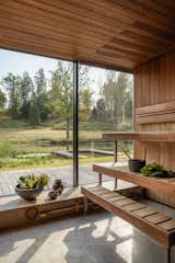 Guests can sauna while looking out to the ponds, the trees, and the expanse of grassland.