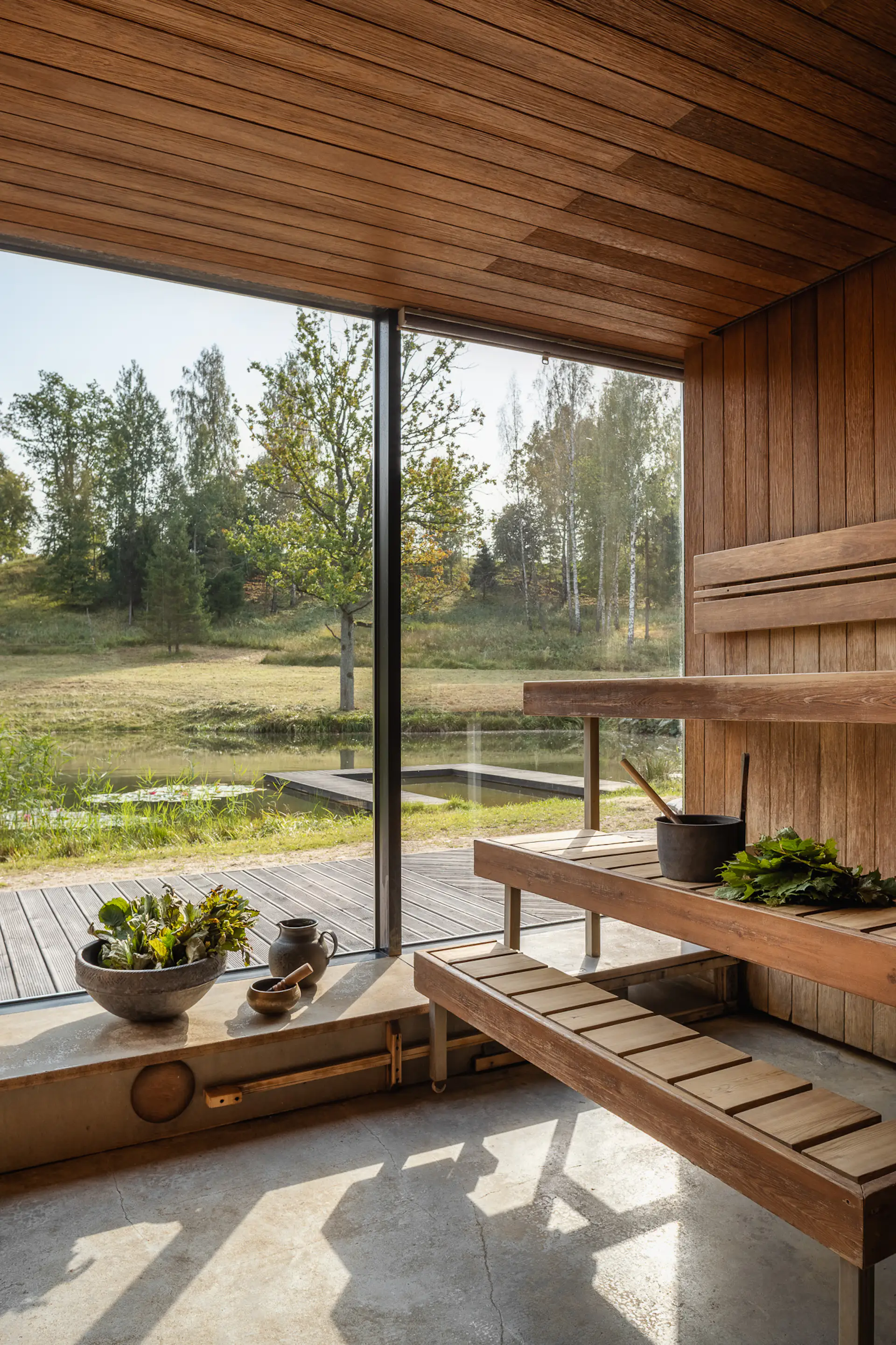 Guests can sauna while looking out to the ponds, the trees, and the expanse of grassland.