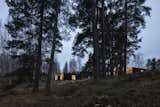 The lakefront villas that Studio Puisto Architects designed for the Uni Resort in Finland are wrapped in cross-laminated timber boards that mimic the tree trunks in the surrounding forest.