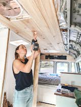 Living Room Clare, above, outfitted the ceiling of the bus with shiplap that gives warmth and texture.  Photo 17 of 20 in An Australian Couple Turn a Bus Into a Traveling Tiny Home and Physical Therapy Practice