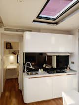 A large skylight fills the kitchen area with sunlight.