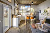 The Park Model, designed by Mint Tiny House Company, measures 535 square feet and features an open plan. Sunlight bounces off the bright-white, tongue-and-groove pine walls.