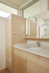 Maple cabinetry in the main bathroom lends warmth and texture.