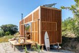 Located in Lisbon, Portugal, the Ursa tiny cabin is wrapped in vertical Thermowood boards.