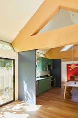 "The large dark blue panels or doors subdivide the space and allow for flexibility,