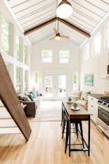 Vinyl plank flooring helps to maintain an affordable price for the cottages, which start at $100,000. Pine beams lend texture and warmth and offset the steel materiality of the ceiling.