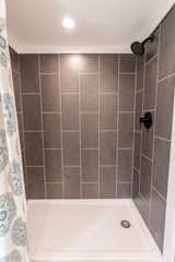 The composite wall system in the shower imitates stone tile and offers durability.