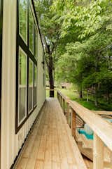 A wraparound porch provides a place to view the natural landscape, connecting the cottage to the outdoors.