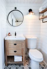 Graphic floor tile adds a playful note to one of the tiny cottage bathrooms.